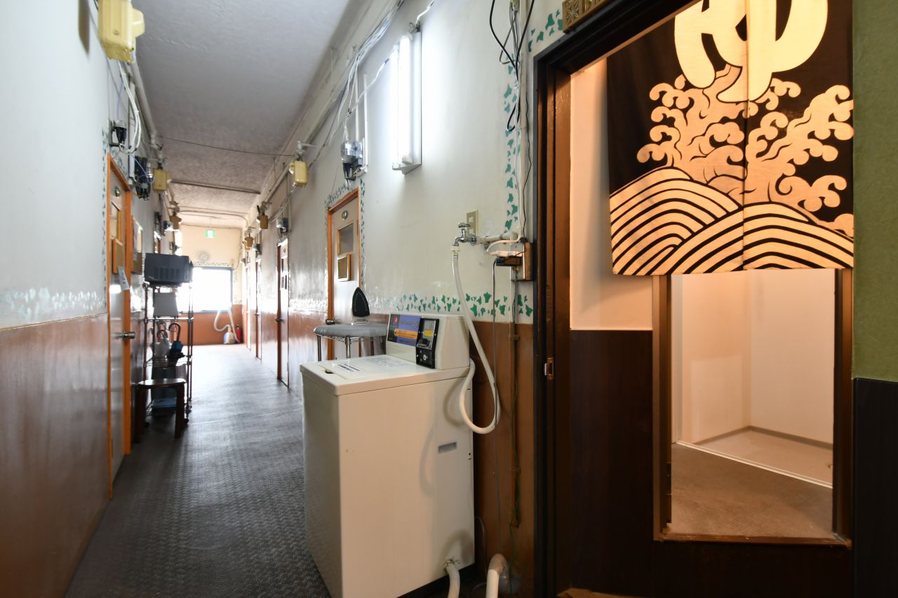 廊下には、洗濯機・乾燥機が設置されています。暖簾の先がシャワールームとトイレです。(2017-08-30,共用部,LAUNDRY,3F)